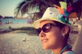 Beautiful young girl watching sunset at the beach