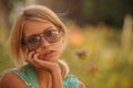 Beautiful young girl watering flowers on the flowerbed. The concept of a good housewife in her house Royalty Free Stock Photo