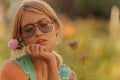 Beautiful young girl watering flowers on the flowerbed. The concept of a good housewife in her house Royalty Free Stock Photo