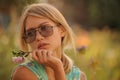 Beautiful young girl watering flowers on the flowerbed. The concept of a good housewife in her house Royalty Free Stock Photo