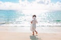 Beautiful young girl wearing angel wings on the beach Royalty Free Stock Photo