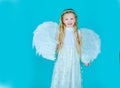 Beautiful young girl wearing angel wings. Child wearing long white dress and angel wings. Cute toddler girl in white Royalty Free Stock Photo