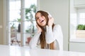 Beautiful young girl wearing headphones listening to music and dancing with a happy face standing and smiling with a confident Royalty Free Stock Photo