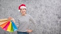 Beautiful young girl wearing a Santa hat holding lots of shopping bags Royalty Free Stock Photo