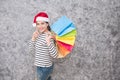 Beautiful young girl wearing a Santa hat holding lots of shopping bags Royalty Free Stock Photo