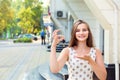 Woman in front of apartment complex office holding giving showing keys