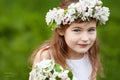 Beautiful young girl in white dress in the garden with blosoming apple trees. Smiling girl having fun and enjoying