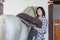 Beautiful young girl and white horse in the stable Royalty Free Stock Photo