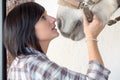 Beautiful young girl and white horse in the stable Royalty Free Stock Photo