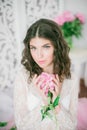 Beautiful young girl in a white lace dress with peony flowers Royalty Free Stock Photo