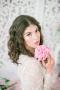 Beautiful young girl in a white lace dress with peony flowers Royalty Free Stock Photo