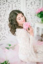 Beautiful young girl in a white lace dress with peony flowers Royalty Free Stock Photo