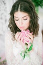 Beautiful young girl in a white lace dress with peony flowers Royalty Free Stock Photo