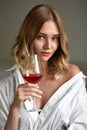 Beautiful young girl in a white shirt with a glass of red wine Royalty Free Stock Photo