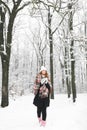 A girl in a plaid drinks tea in winter