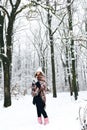 A girl in a plaid drinks tea in winter