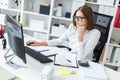 Young girl sitting at the table and working with a computer, documents and calculator Royalty Free Stock Photo