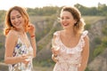 Beautiful young girlfriend girls drink wine, laugh and have a good time in a picturesque place