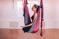 Beautiful young girls doing fly yoga on hammocks, meditating on hammocks, health care