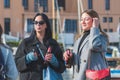 Beautiful young girls drinking beer and having fun on the pier of the small port of Bari