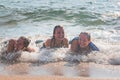 Waves Splash Girls Laying on the Sand