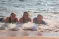 Waves Splash Girls Laying on the Sand Royalty Free Stock Photo