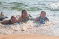 Waves Splash Girls Laying on the Sand Royalty Free Stock Photo