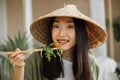 Beautiful young and happy asian woman eating healthy salad with fresh organic vegetables Royalty Free Stock Photo