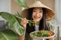 Beautiful young and happy asian woman eating healthy salad with fresh organic vegetables Royalty Free Stock Photo