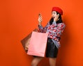 Woman holding shopping bag and using smartphone for shopping online, shopping concept. Royalty Free Stock Photo