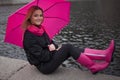 Beautiful young and happy blond woman with colorful umbrella on the street. The concept of positivity and optimism Royalty Free Stock Photo