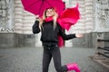 Beautiful young and happy blond woman with colorful umbrella on the street. The concept of positivity and optimism Royalty Free Stock Photo