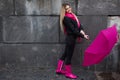 Beautiful young and happy blond woman with colorful umbrella on the street. The concept of positivity and optimism Royalty Free Stock Photo