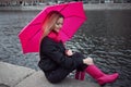 Beautiful young and happy blond woman with colorful umbrella on the street. The concept of positivity and optimism Royalty Free Stock Photo