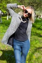 Beautiful young happy blonde girl in coat, jeans and sunglasses Royalty Free Stock Photo