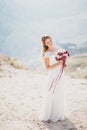 Beautiful young happy bride standing on the top of the mountain Royalty Free Stock Photo