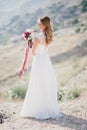 Beautiful young happy bride standing on the top of the mountain Royalty Free Stock Photo