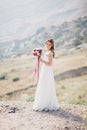 Beautiful young happy bride standing on the top of the mountain Royalty Free Stock Photo