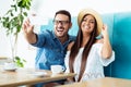 Young happy couple doing selfie in a cafe Royalty Free Stock Photo