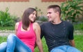 Beautiful young happy couple sitting in the garden Royalty Free Stock Photo