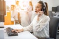 Beautiful young happy smiling female customer support phone operator at workplace. Royalty Free Stock Photo