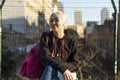 Beautiful young happy smiling woman against the background of a European city