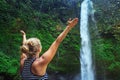 Beautiful young happy woman enjoying nature under tropical fresh waterfall Royalty Free Stock Photo