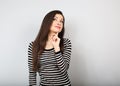 Beautiful young happy woman with finger under the face thinking and looking up Royalty Free Stock Photo