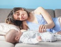 Beautiful young happy woman with her newborn baby lies on the co Royalty Free Stock Photo