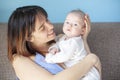 Beautiful happy young brunette woman with newborn baby on her hands, family happiness, love and care concept, mother day Royalty Free Stock Photo