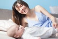 Beautiful young happy woman with her newborn baby lies on the co Royalty Free Stock Photo