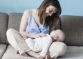 Beautiful happy young brunette woman with newborn baby on her hands, family happiness, love and care concept, mother day Royalty Free Stock Photo