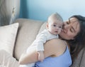 Beautiful happy young brunette woman with newborn baby on her hands, family happiness, love and care concept, mother day Royalty Free Stock Photo