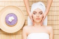 Beautiful, young and healthy woman on bamboo mat in spa salon ha Royalty Free Stock Photo